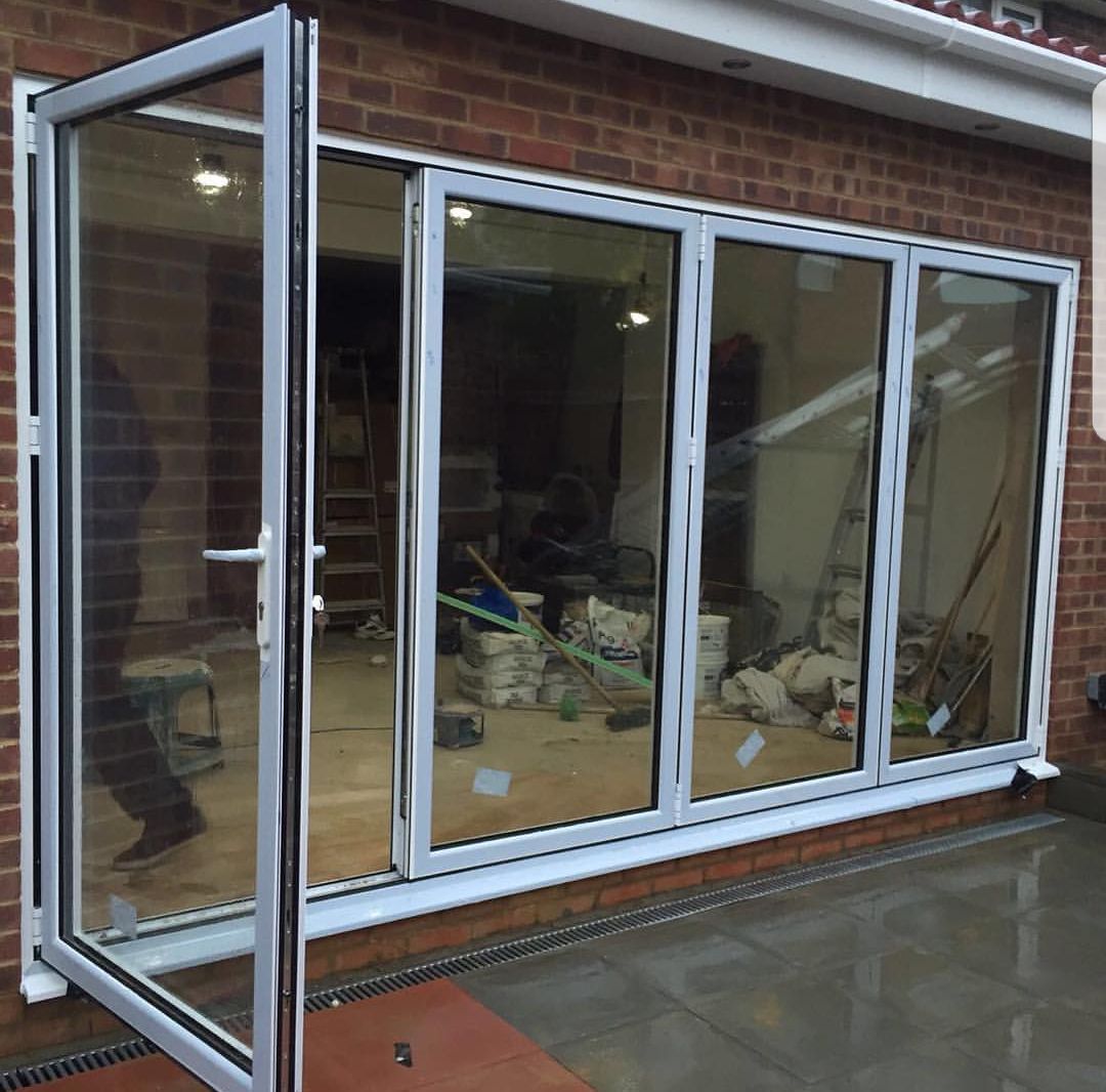 A brick building with a large window and sliding glass doors