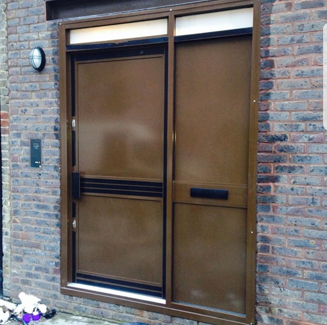 A brown door is on a brick building