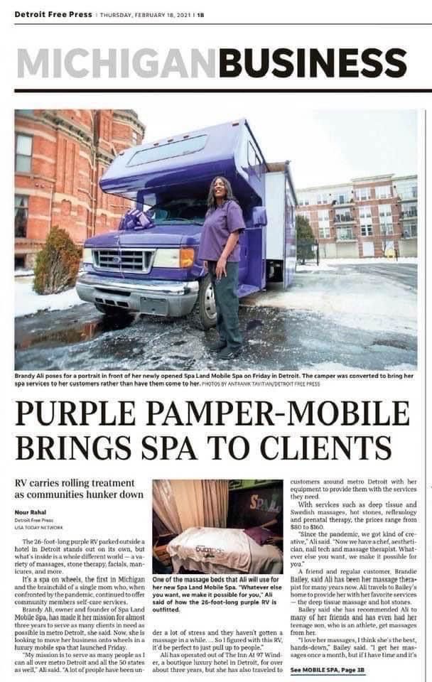 A woman is standing next to a purple truck on the front page of a newspaper.