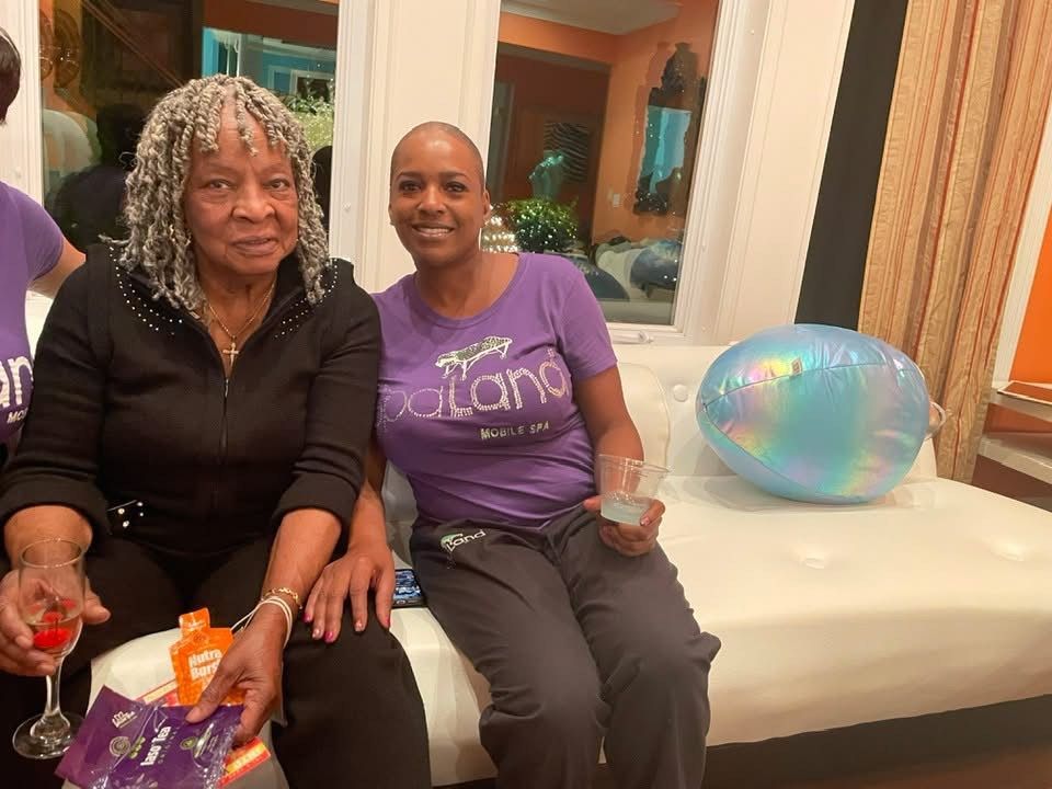 Two women are sitting on a couch with one wearing a purple shirt that says piano