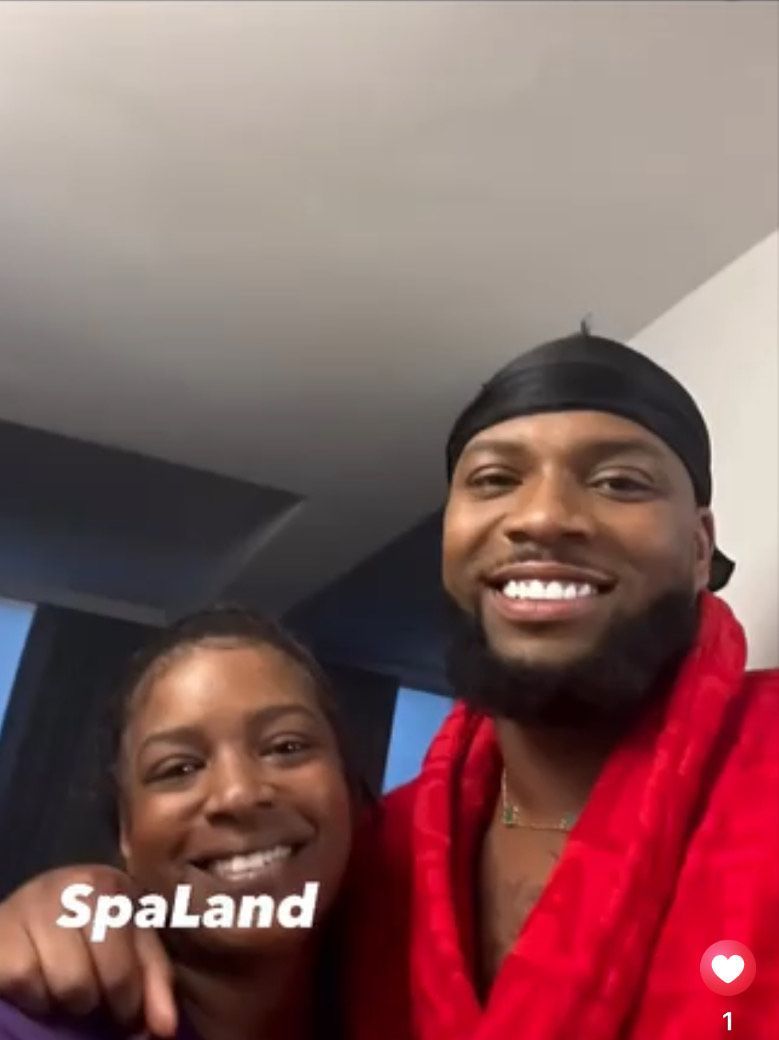 A man and a woman are posing for a picture with the caption spaland