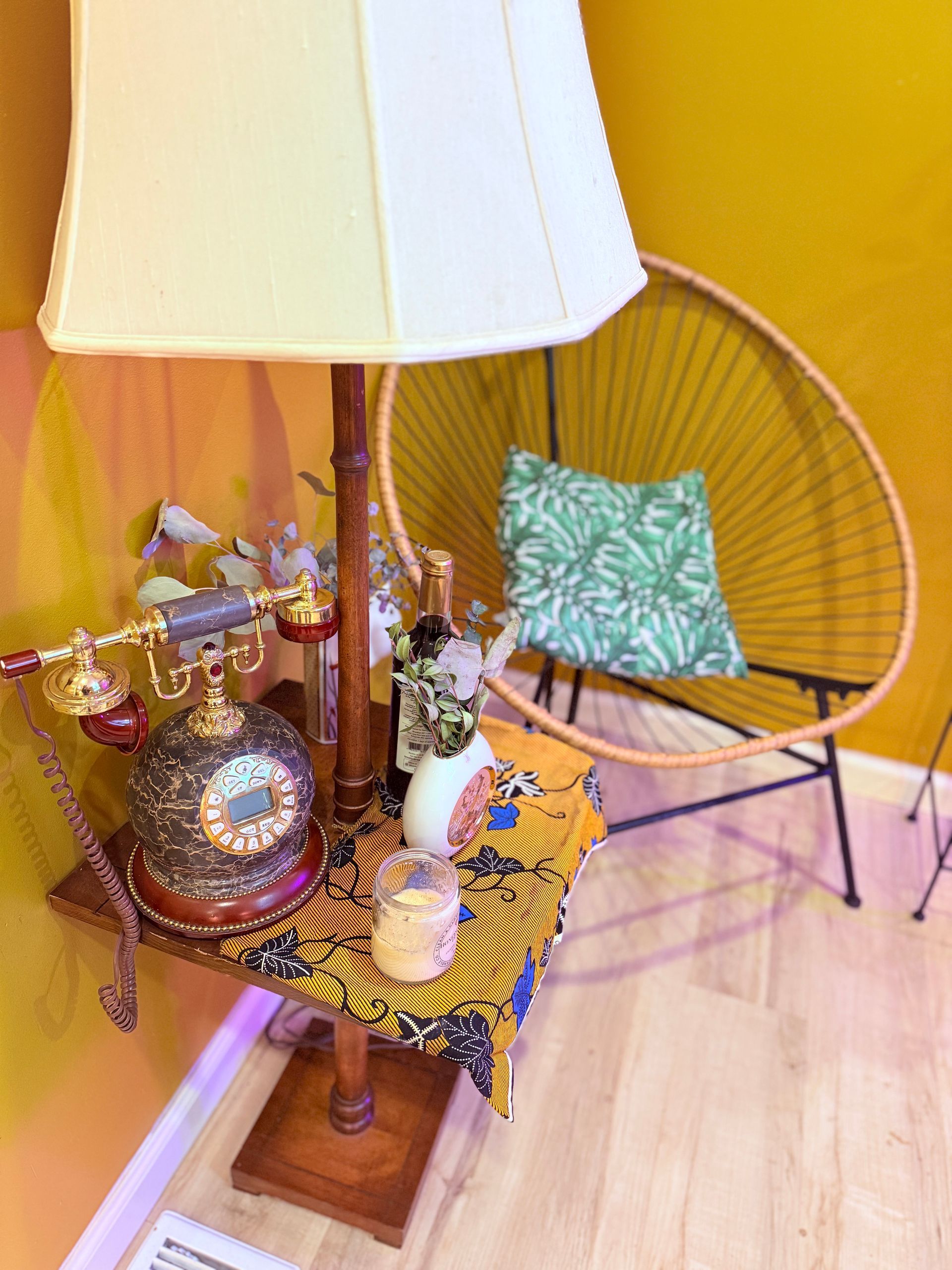 A lamp is sitting on a table next to a chair