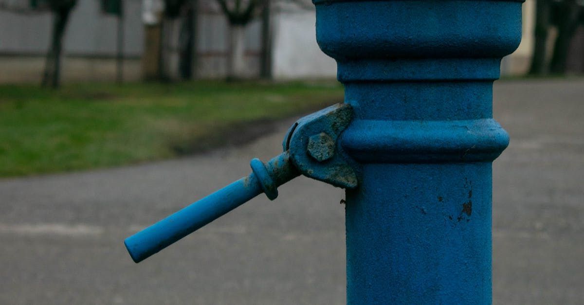 a close up of a blue pole with a handle on it