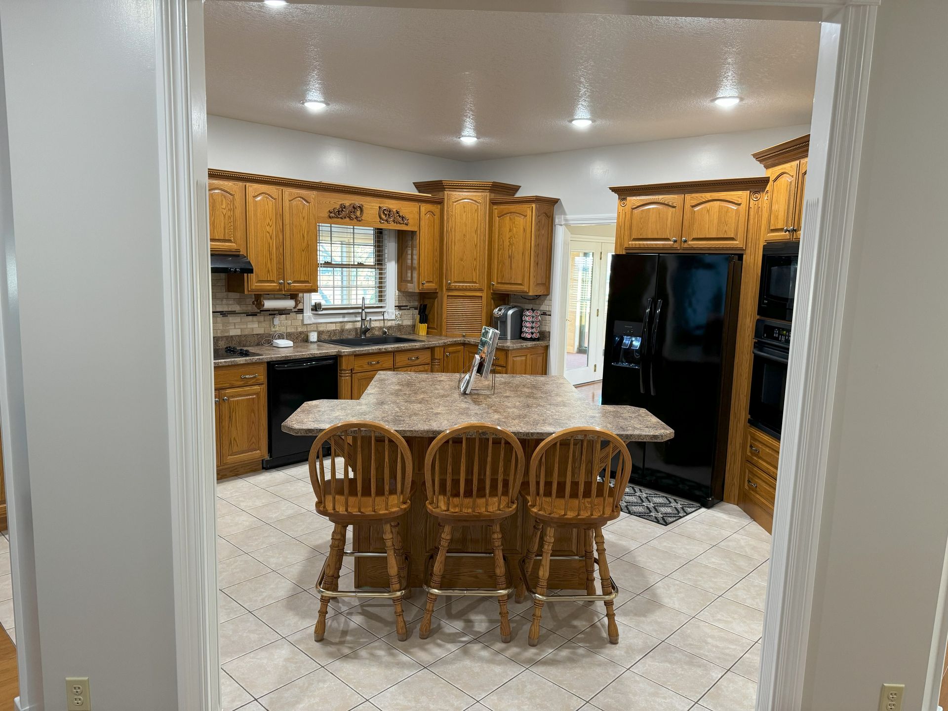 A kitchen with a large island in the middle of it.