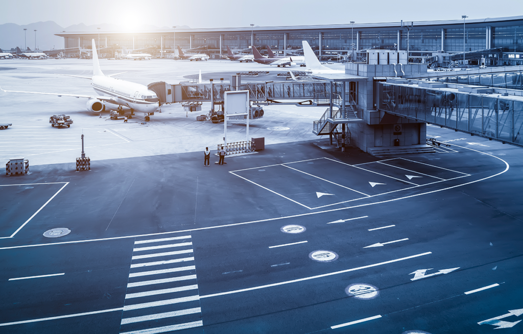 An aerial view of an airport with planes parked on the tarmac.