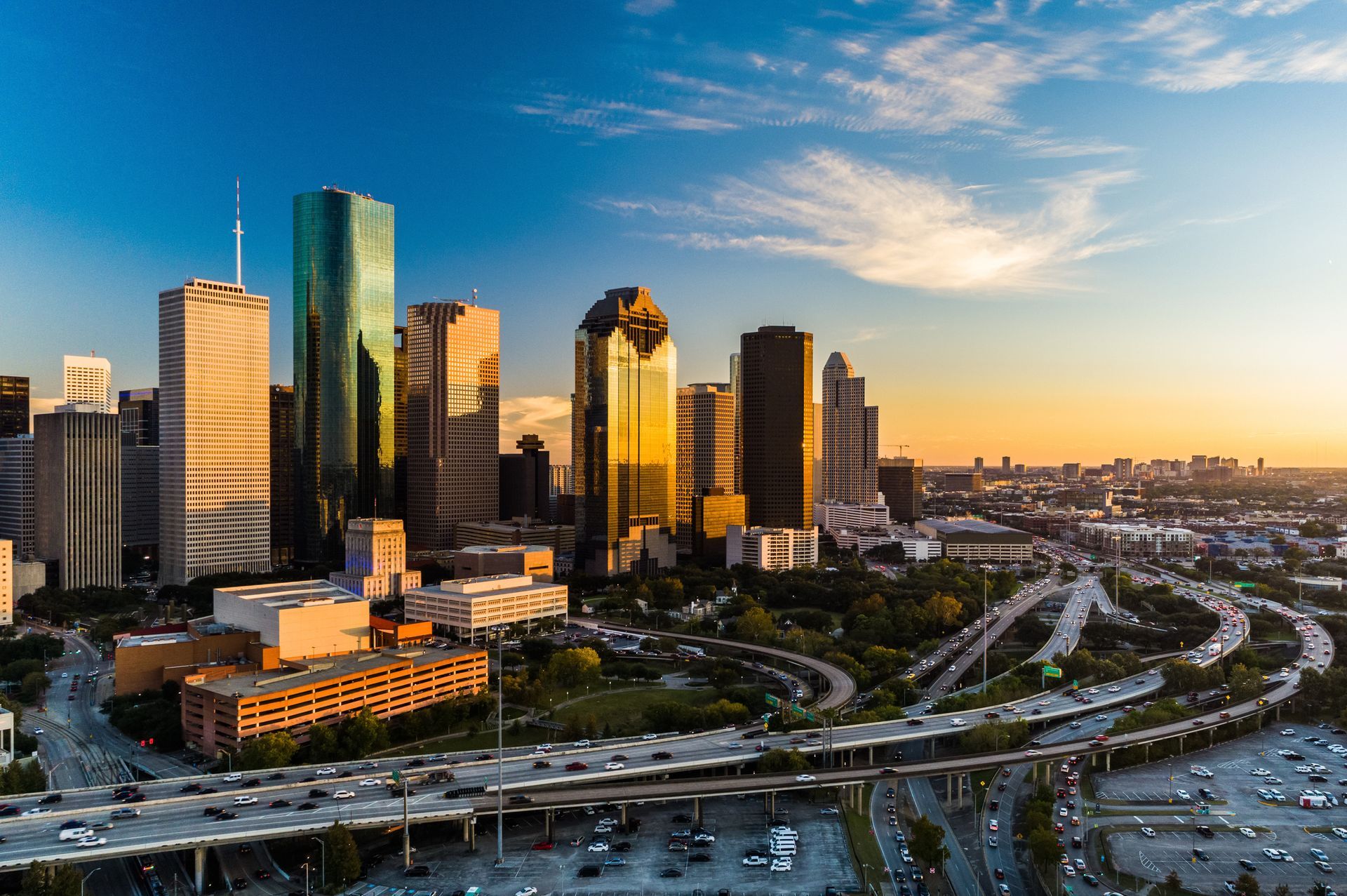 An aerial view of a city skyline at sunset.