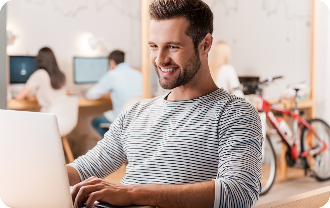 man looking at laptop screen showing data graphs