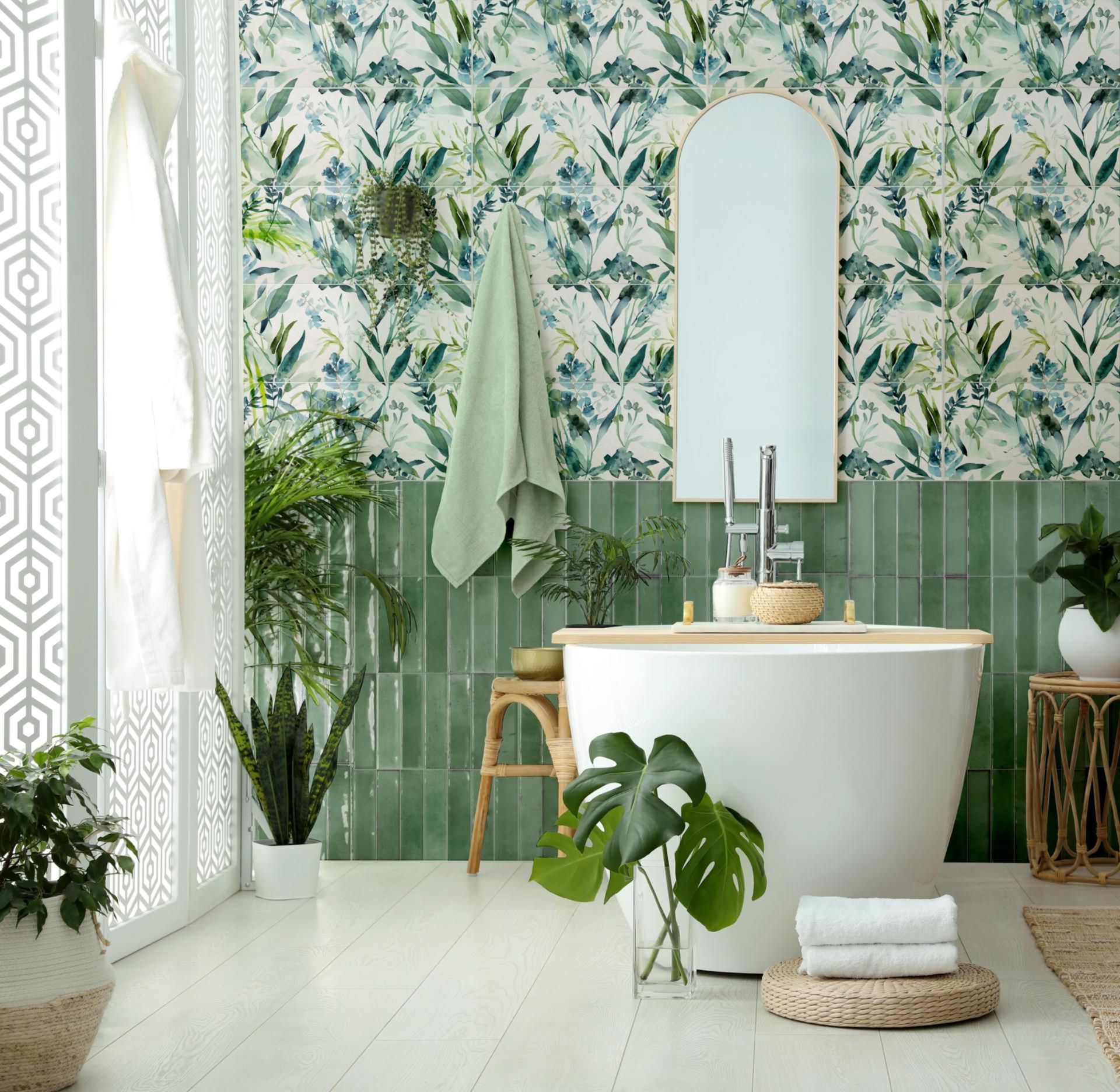 Un bagno con vasca, specchio e piante