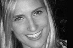 Blond woman smiling, close-up in black and white.