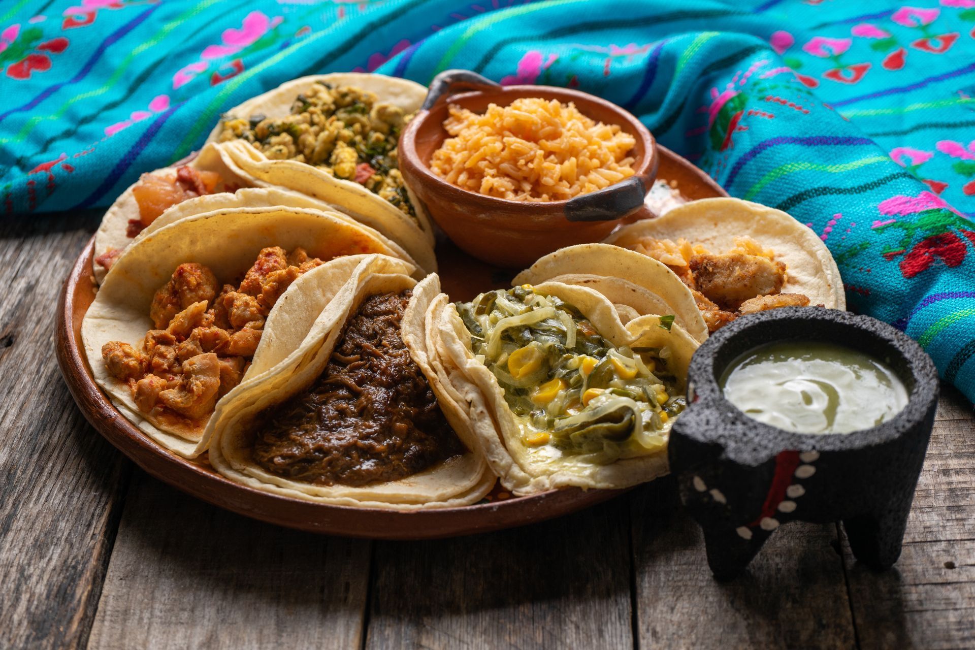 There are many different types of tacos on the plate.