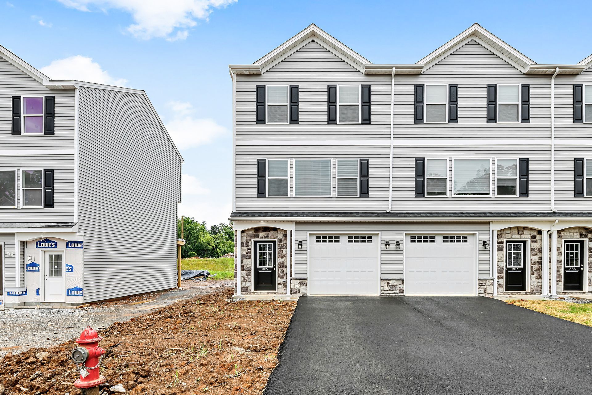 A large white house with a fire hydrant in front of it.