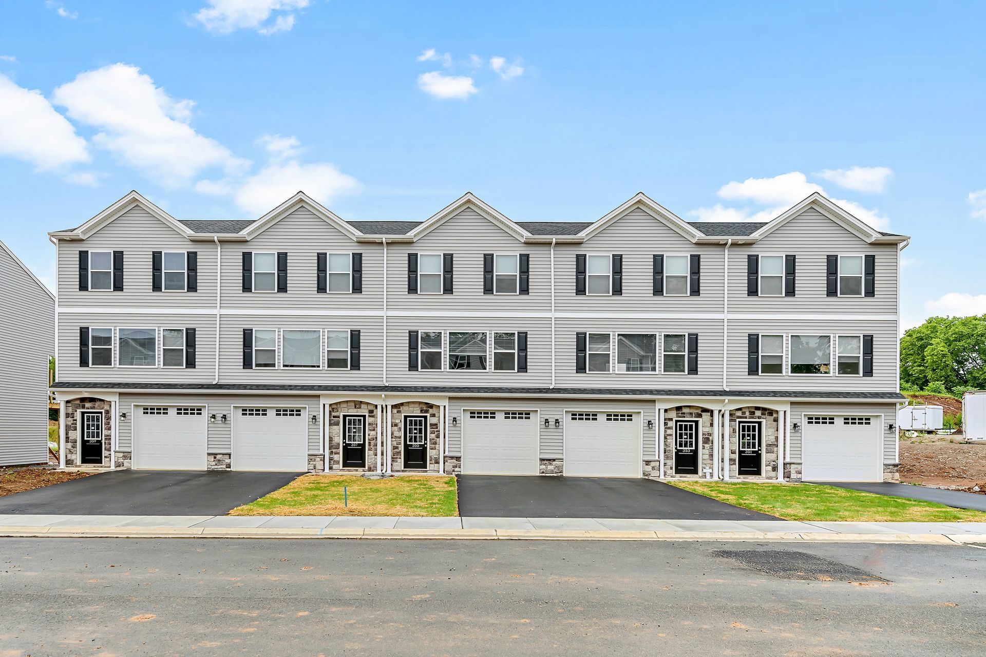 A large apartment building with a lot of windows and garages.