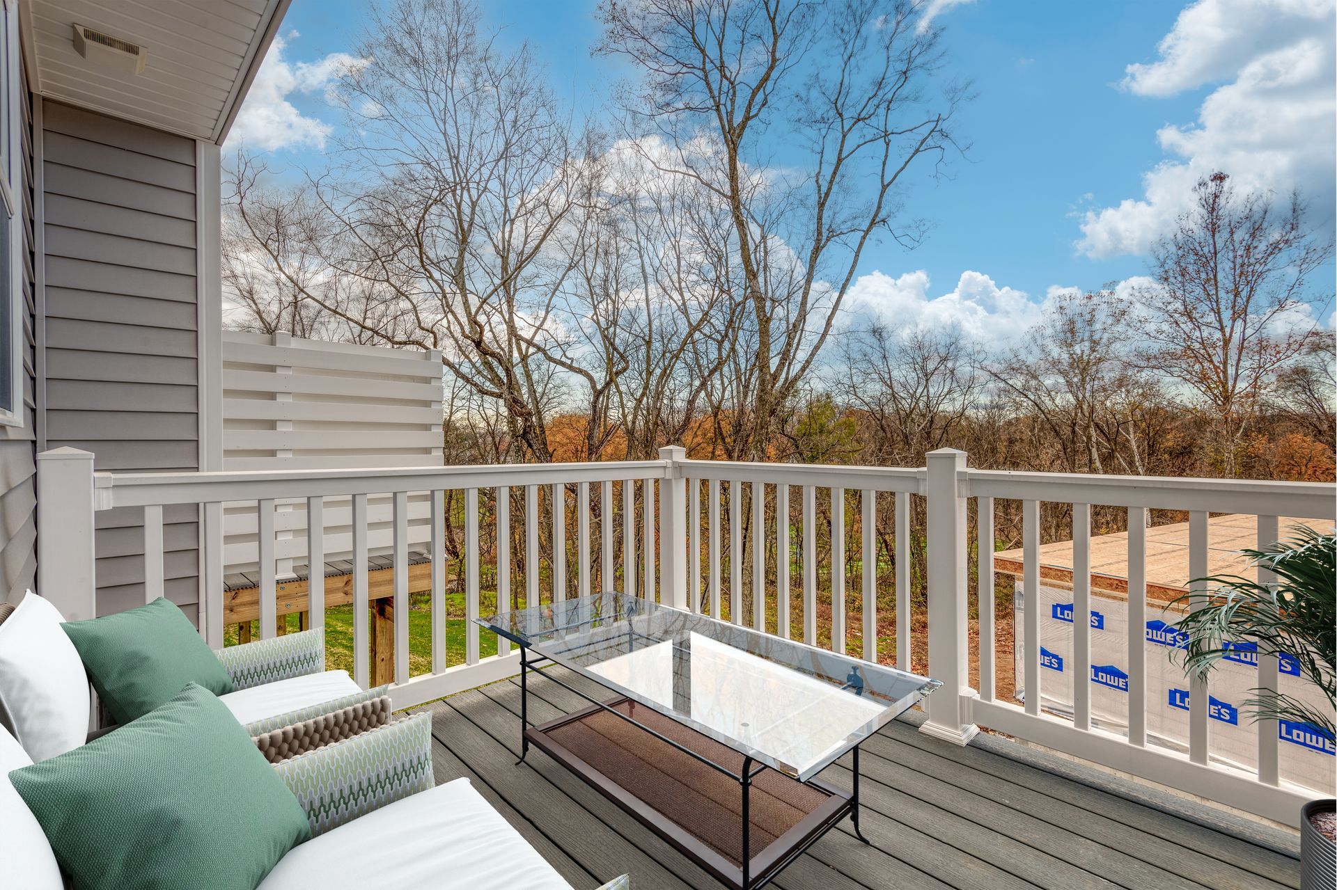 There is a balcony with a table and chairs on it.