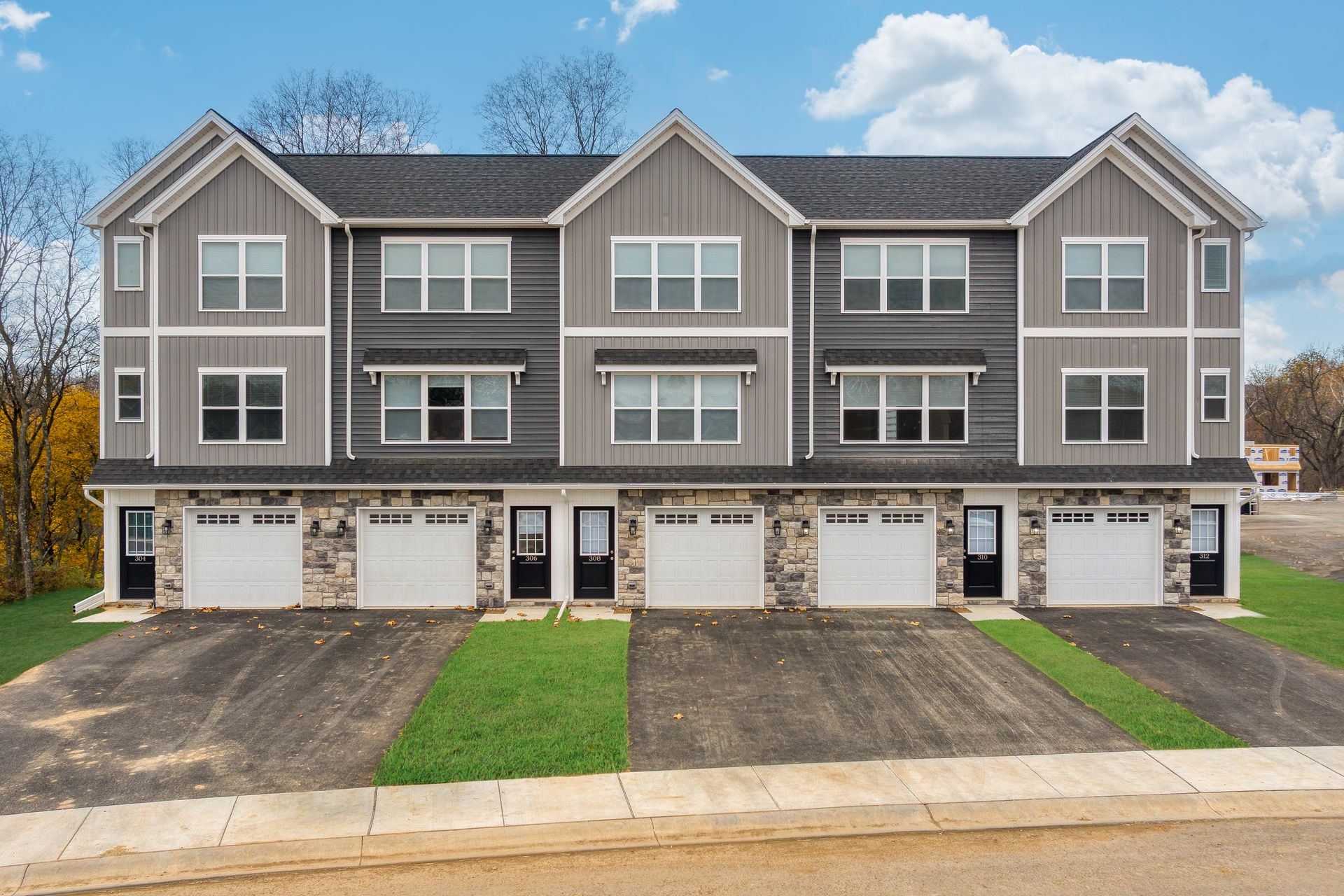 A row of apartment buildings with a lot of windows and garages.