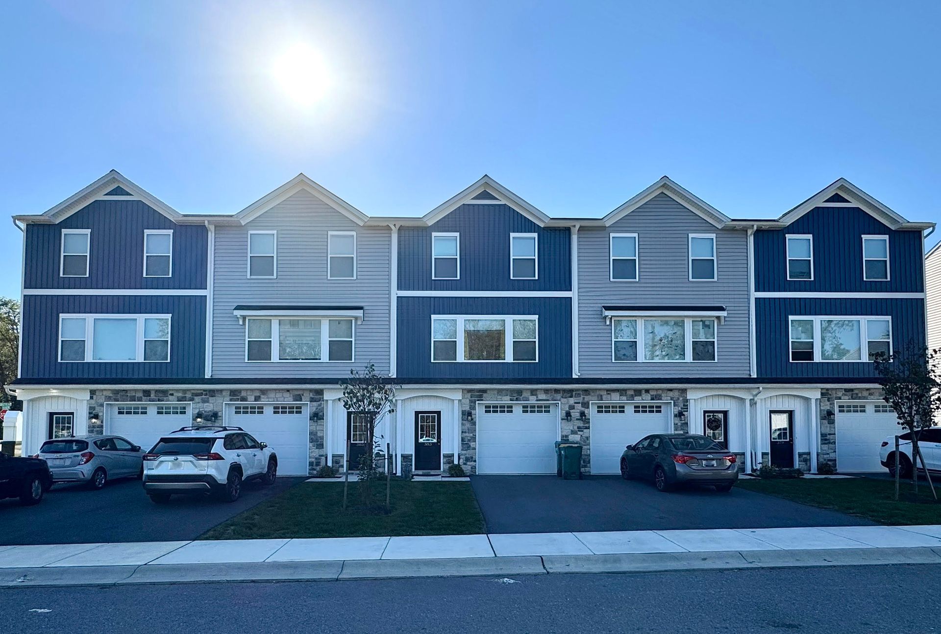 A large apartment building with a lot of windows and garages.