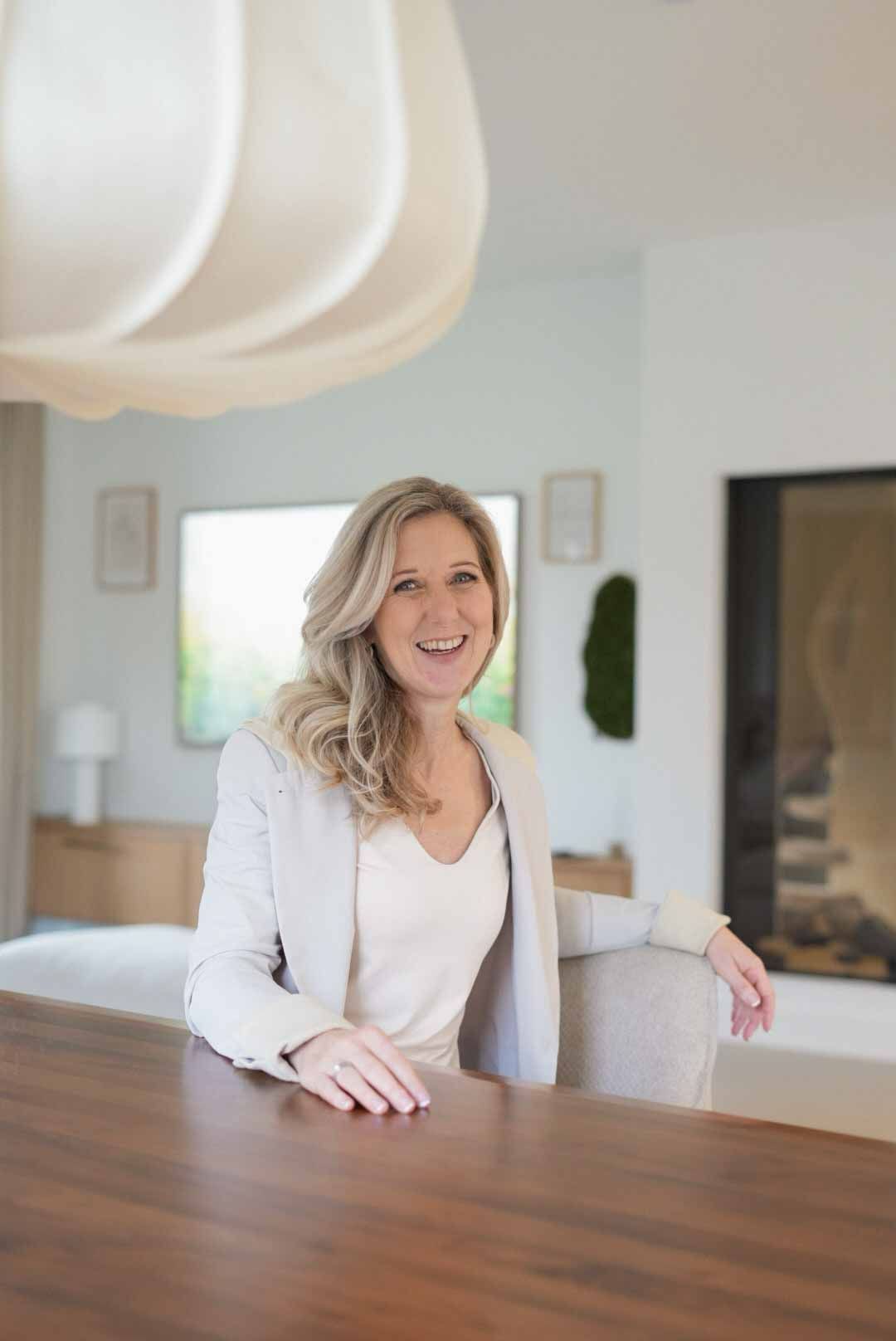 Een vrouw met krullend haar bidt met haar ogen dicht.