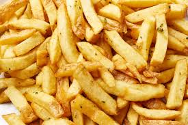 A pile of french fries on a white plate.