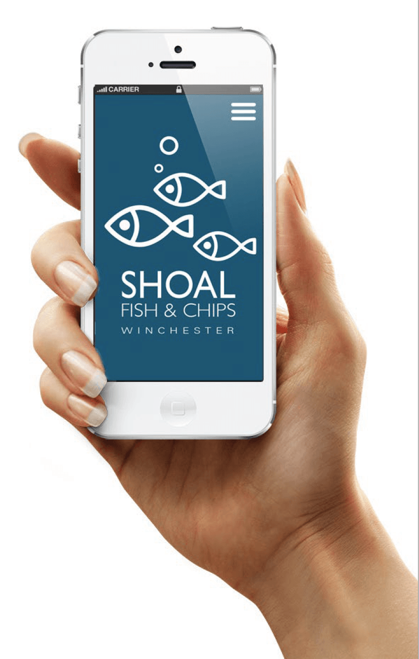 A hand is holding a cell phone with shoal fish and chips on the screen.