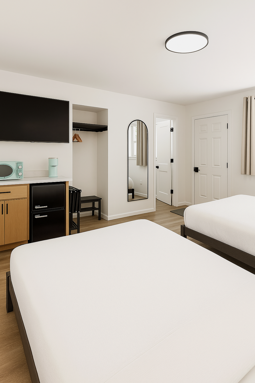 A motel room with two beds, a TV, a fridge, and a mirror. White walls, light brown floors.