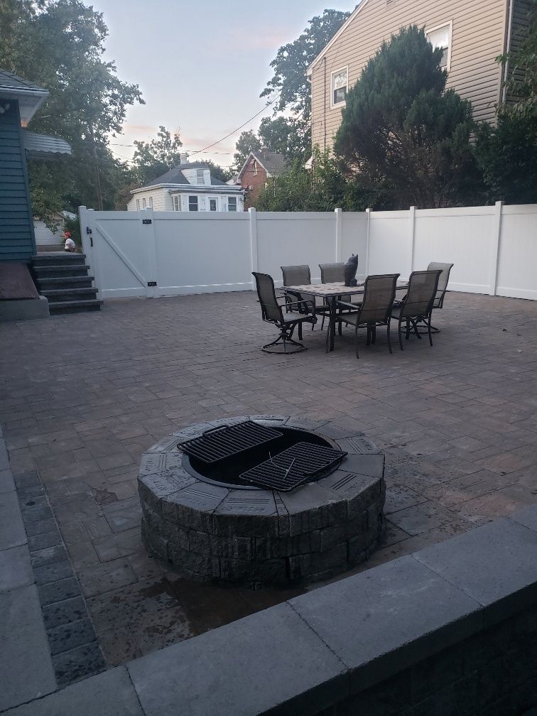 A patio with a table and chairs and an umbrella.