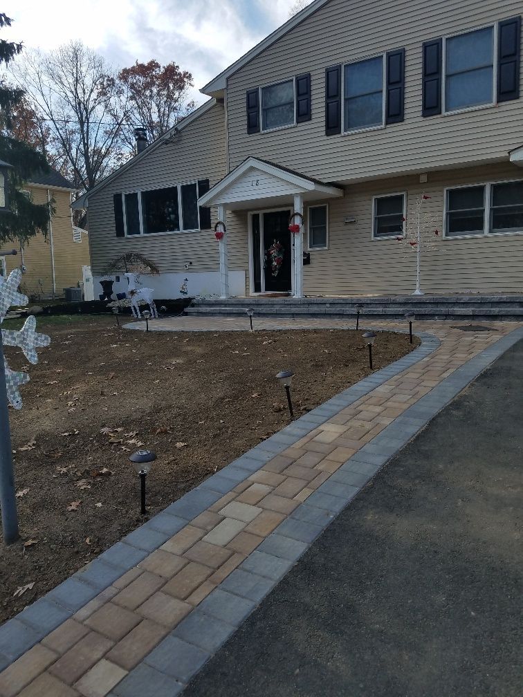 A large house with a brick walkway leading to it