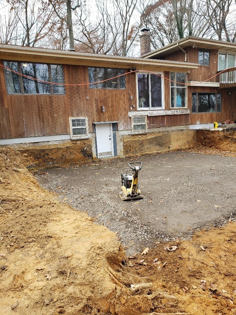 A yellow bulldozer is moving dirt in a field.