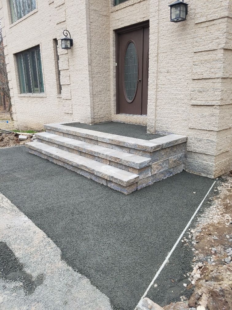 A house with stairs leading up to the front door.