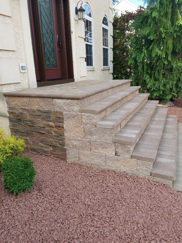 A set of stairs leading up to the front door of a house.