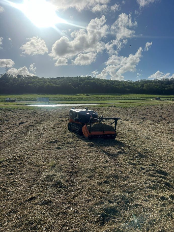 A Lawn Mower is Sitting in the Middle of a Field — NQ Steep Terrain Mulching and Clearing in The Leap, QLD