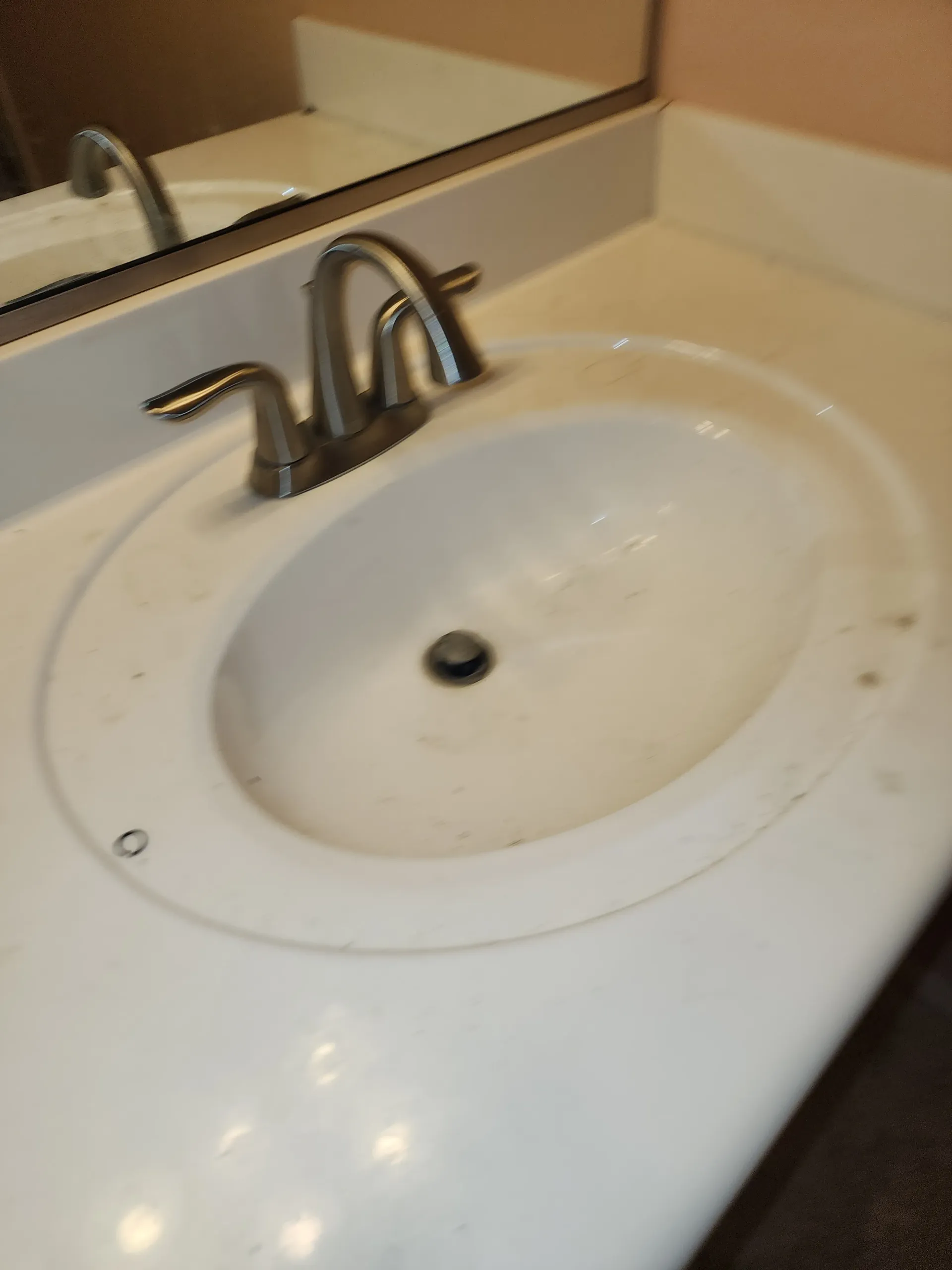 a bathroom sink with a faucet and a mirror