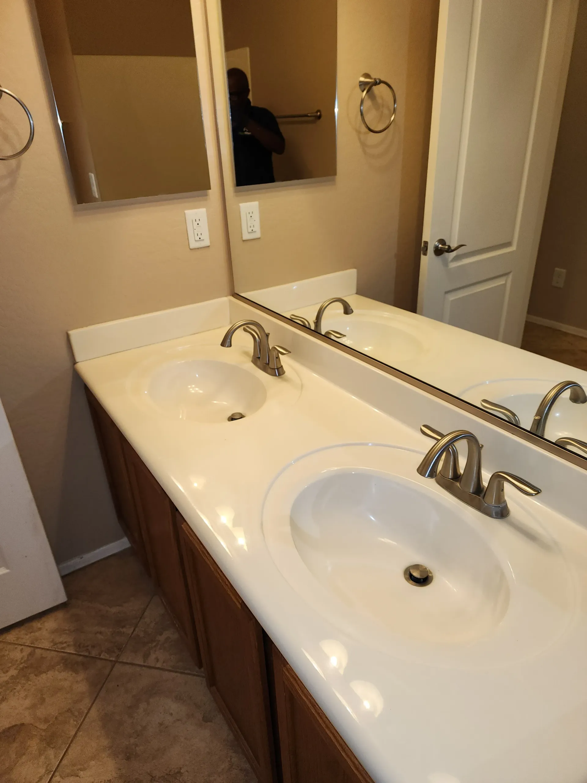 a bathroom with two sinks and a mirror .