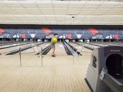 A person is throwing a bowling ball down a bowling alley.