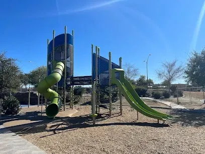 a playground with a green slide and a green tube .