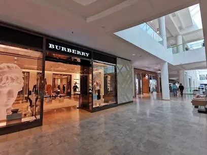 There is a burberry store in the middle of a mall.