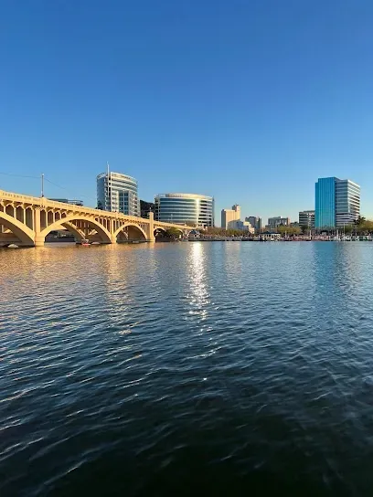 A bridge over a body of water with a city in the background.