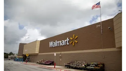 A walmart store with an american flag flying in front of it