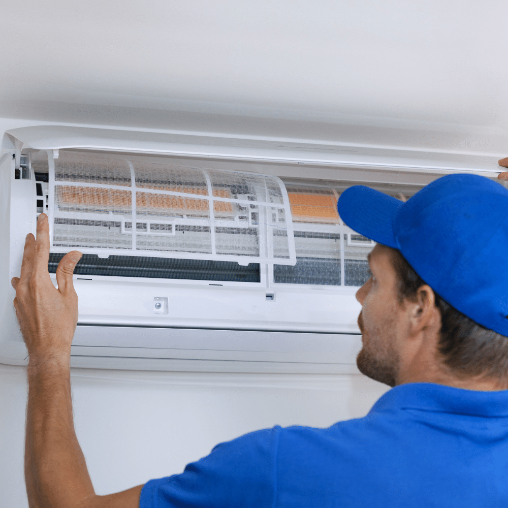 Man changing air conditioner filter