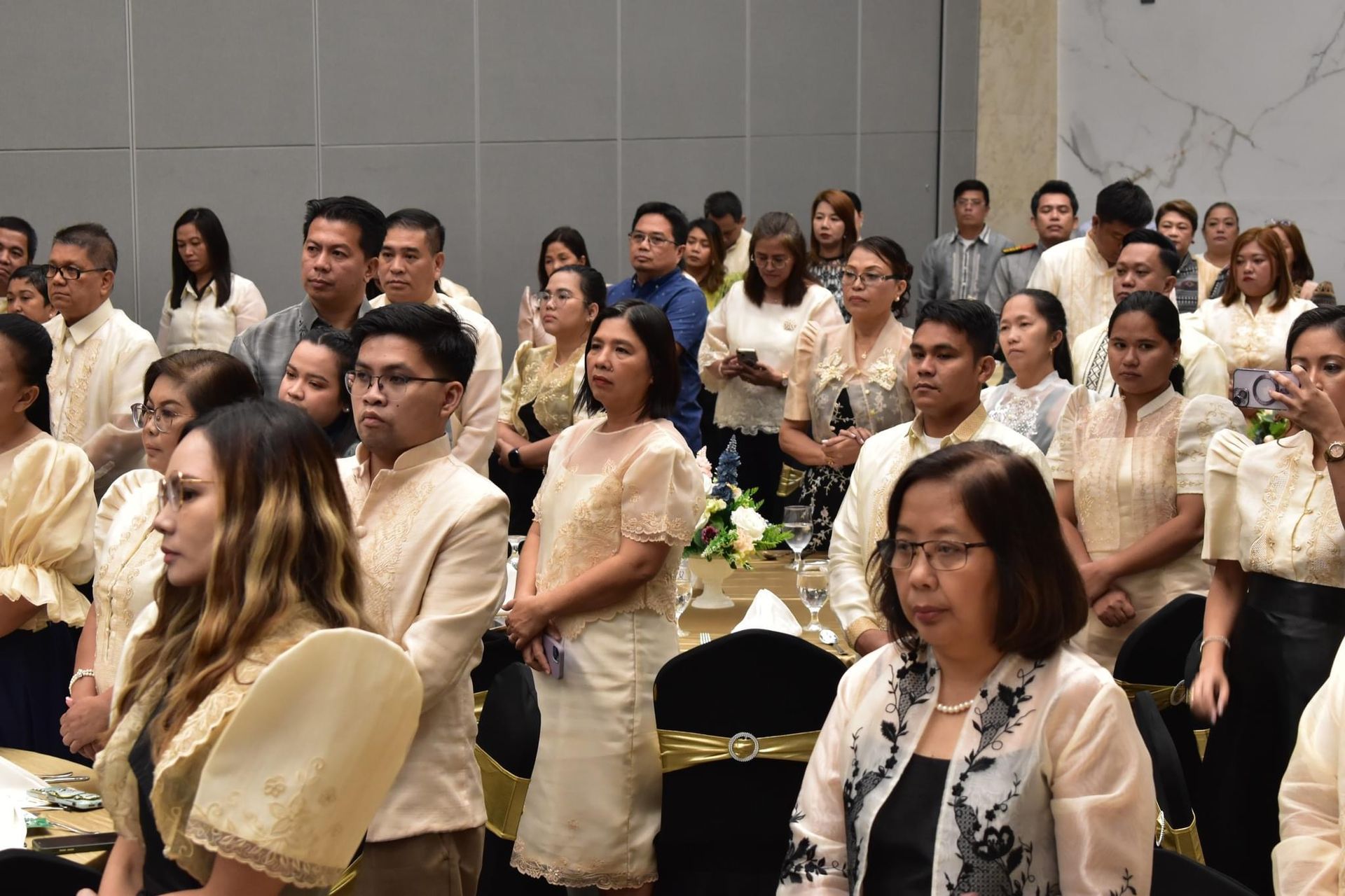 A large group of people are sitting in a room.