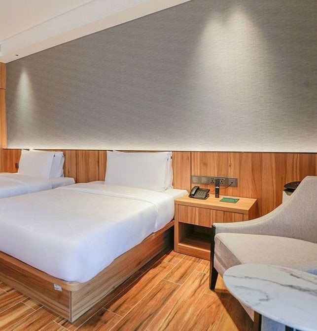 Hotel Casiana's room with two beds and a chair