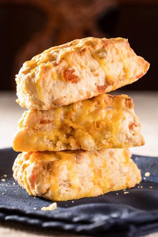 Three biscuits are stacked on top of each other on a napkin.
