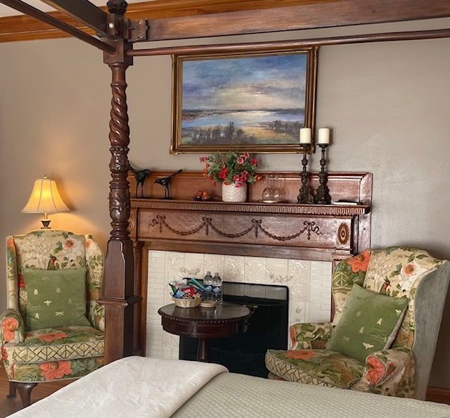 A bedroom with a four poster bed and a fireplace