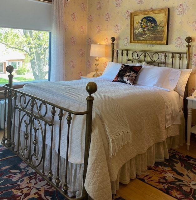 A bedroom with a bed and a painting on the wall