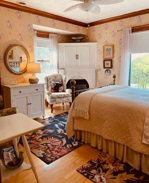 A bedroom with a large bed and a ceiling fan