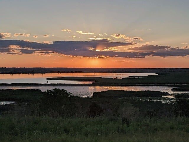 The sun is setting over a body of water