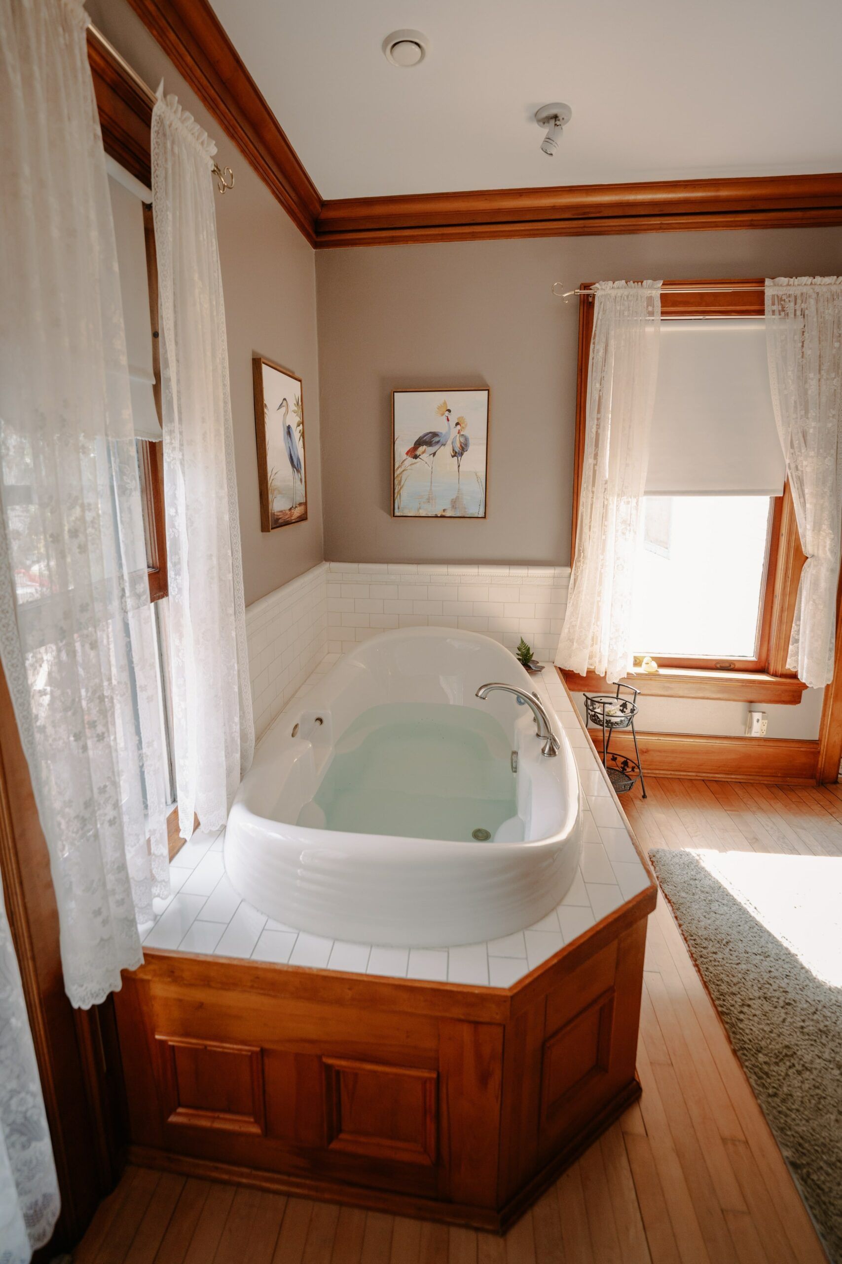 A bathroom with a jacuzzi tub and a window.