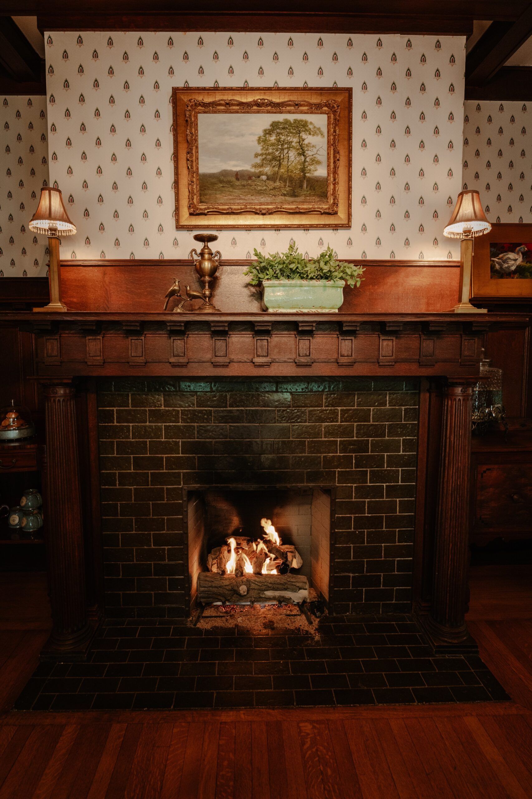 A fireplace with a painting on the wall above it