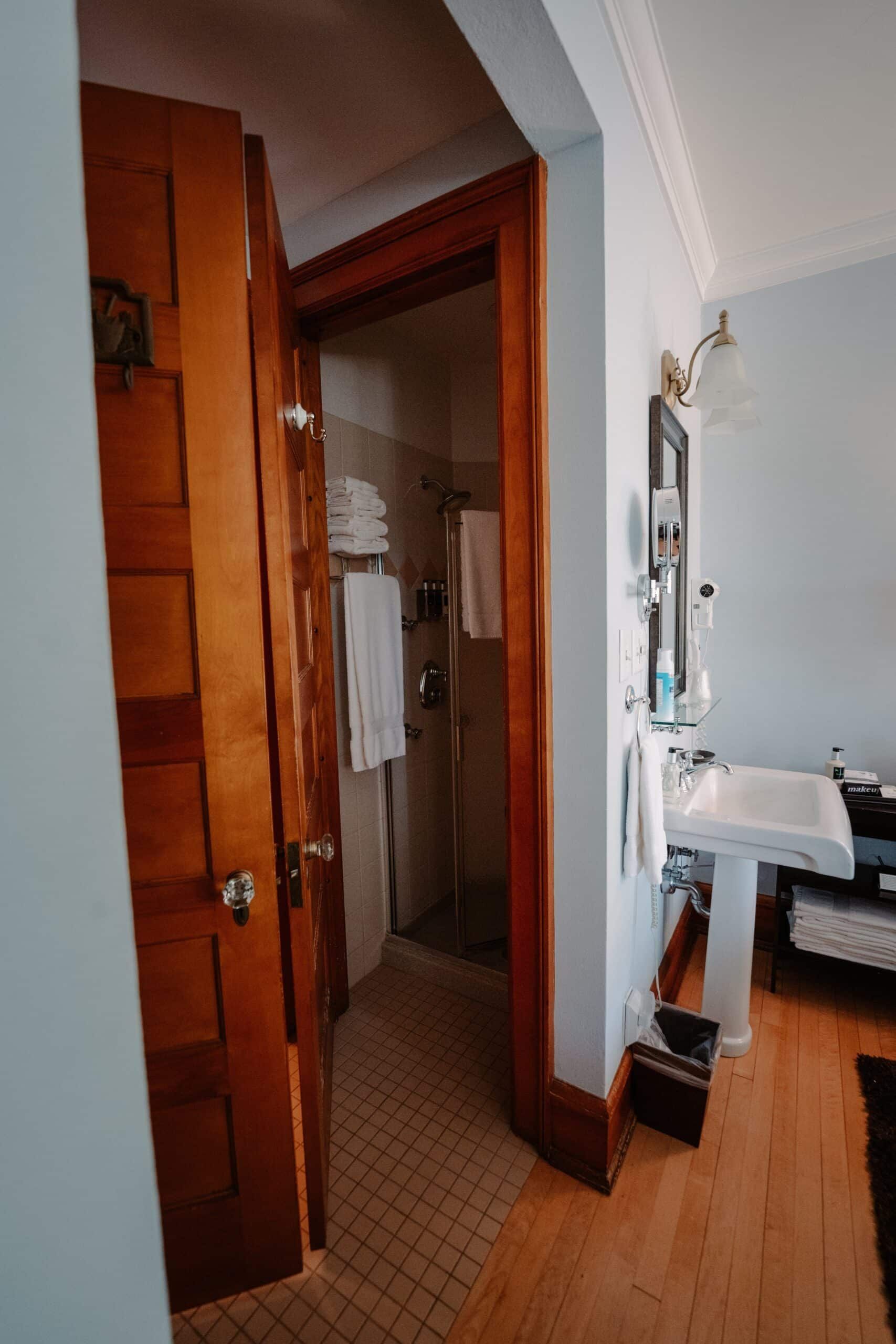 A bathroom with a sink , mirror , and shower.