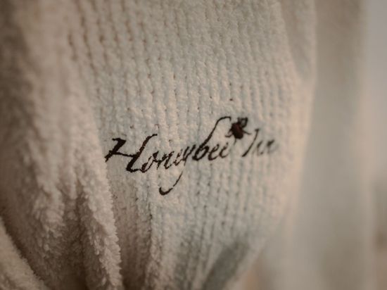 A close up of a white towel with the word honeybee on it.