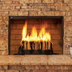 A brick fireplace with flames coming out of it.