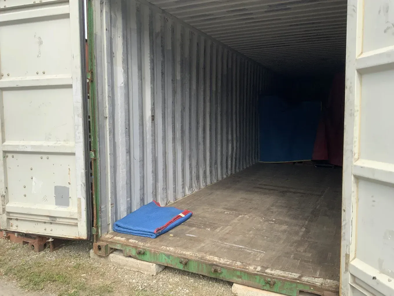 Storage Units With Green And White Doors. Cardboard Boxes And Furniture — Cairns Budget Storage In Mount Sheridan, QLD